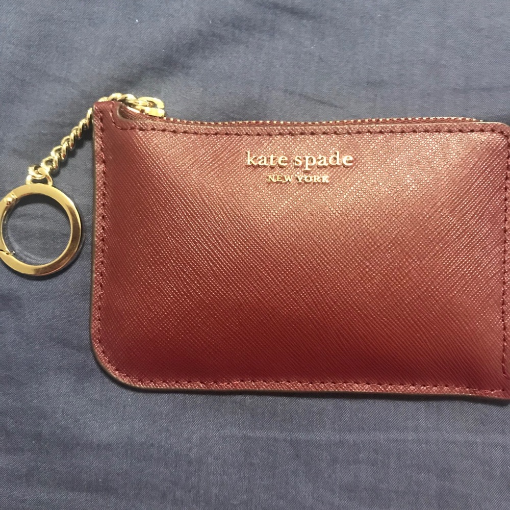 Two coin purses for sale: Coach and Kate Spade.